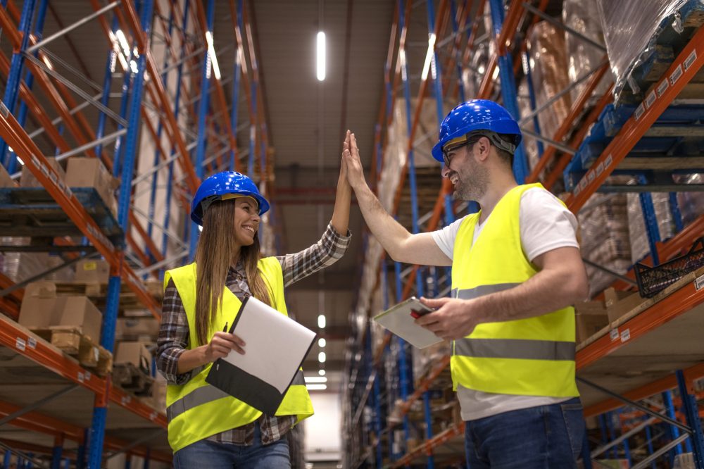 Warehouse workers clapping hands together.